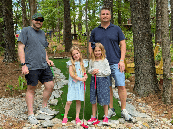 Family playing outdoor mini golf at Putt Forest in Raleigh North Carolina